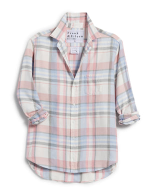 The FRANK & EILEEN's EILEEN Relaxed Button Up Shirt in pastel pink, blue, and gray plaid hangs against a white background. It offers a relaxed fit, rolled-up sleeves, Italian Cashmere Touch material, a single chest pocket, bust-flattering buttons, and an inner collar label.