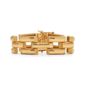 A close-up view of the CAPUCINE DE WULF - PATHWAY LINK BRACELET, GOLD showcases its handcrafted rectangular, textured links connected in a bold geometric pattern. This 18K gold bracelet features a shiny finish and clasp closure from the esteemed brand, CAPUCINE DE WULF.