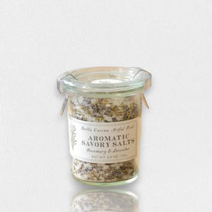 A small glass Weck jar with a metal clasp lid containing a seasoning blend. The label reads "BELLA CUCINA - ROSEMARY & LAVENDER SALT," offering a delightful Mediterranean flavor. The 2.6-ounce (75g) salt mixture is visible through the glass.