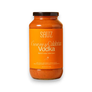 A jar of SAUZ - Creamy Calabrian Vodka Sauce is displayed against a white background. The label is orange with white and yellow text, highlighting it as a rich and creamy vodka sauce infused with Calabrian Chilis. The product weight is specified as 24.5 ounces.