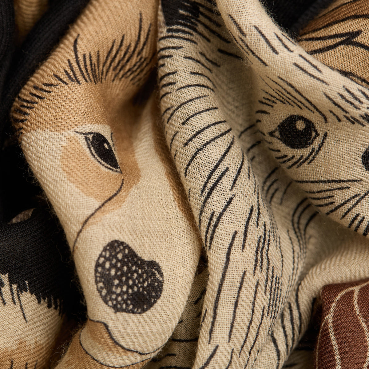 The INOUI EDITIONS - TOUTOU DOGGIE WOOL SCARF by INOUI features illustrated dogs of various breeds, sizes, and colors playfully arranged on a dark background. Made in India.