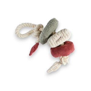 Introducing the LAMBWOLF COLLECTIVE - VALENTINE BLOCS by LAMBWOLF COLLECTIVE: a vibrant Valentine edition dog toy featuring three plush rings in shades of green, white, and red, all attached to a sturdy knotted rope. The rings offer varied textures to delight any avid dog chewer. The rope forms a convenient loop at one end for easy gripping during playtime. The background is white.