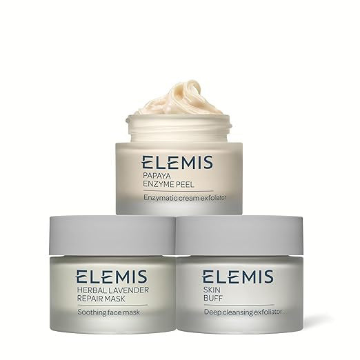 Image of a product package for "KIT DEEP CLEANSING MASK TRIO" by ELEMIS - STEINER. The box is upright with a light blue background and features images of three cream smears in white and light blue. Text details product information and benefits in English and French to exfoliate, purify, and brighten your skin.