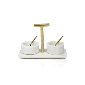 The MARBLE CONDIMENT BOWLS W SPOON by ZODAX, elegantly designed with two round containers on a rectangular base, has product dimensions of 8 in x 3.75 in x 5.75 in. Each container features a small golden spoon and a central T-shaped handle for easy lifting, adding a modern touch to your kitchen decor.