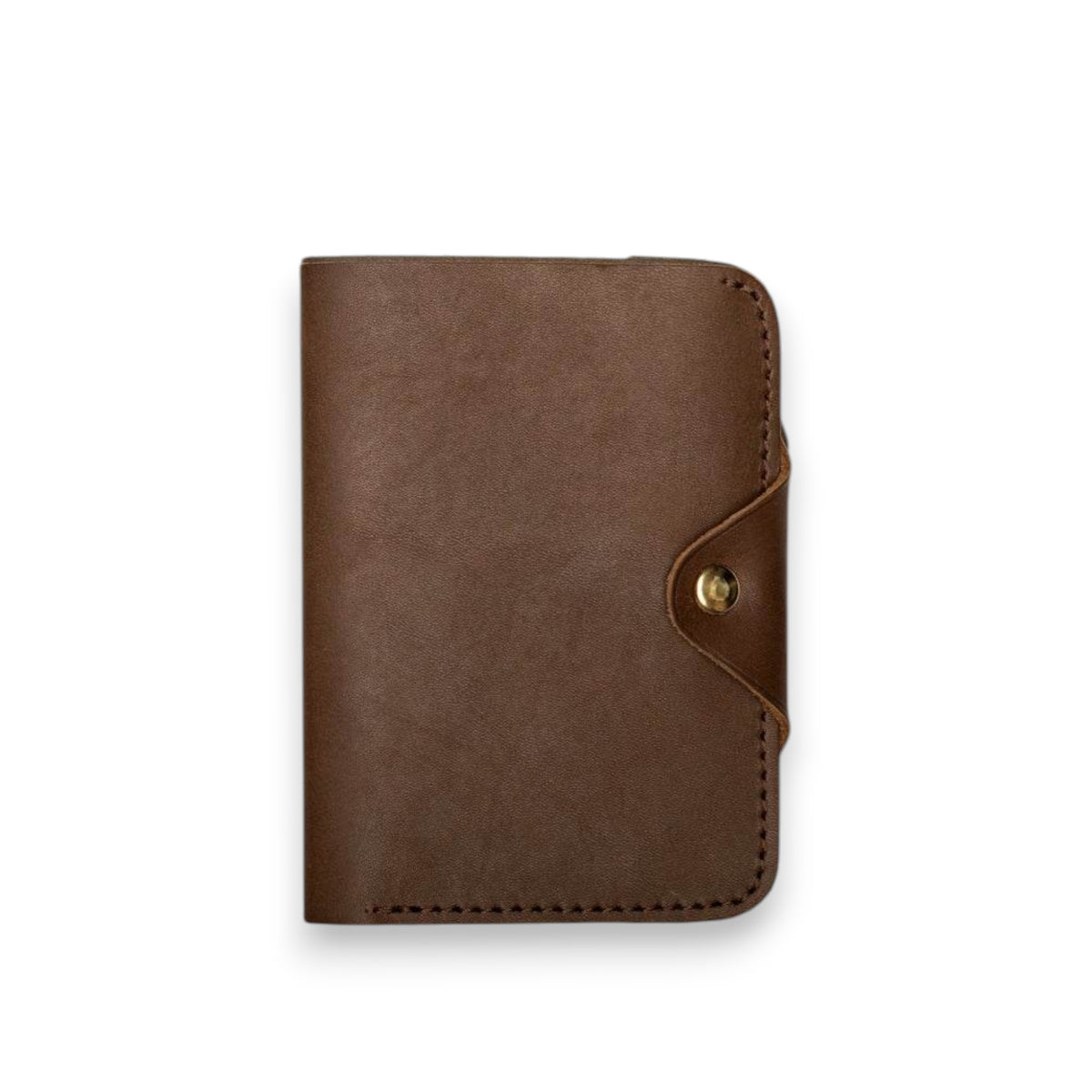 The WP STANDARD - LEATHER PASSPORT WALLET IN CHOCOLATE BROWN by WP STANDARD is open, showing a US passport inside. It has a left pocket and a button snap closure on the right, displayed against a white background.