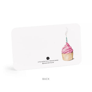 The "PINK CUPCAKE LITTLE NOTES" from E.FRANCES PAPER features an enchanting cupcake design with pink frosting and a lit candle. This adaptable card, characterized by its rounded corners and subtle logo, is elegantly displayed against a simple white background.