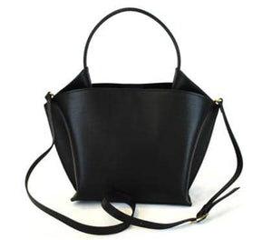 Introducing the RIGID LEATHER HANDBAG by LEATHER COUNTRY, a stylish black handbag with a unique geometric shape, featuring a top handle and a removable shoulder strap. The bag boasts gold-tone hardware, a magnetic closure, and an unlined interior spacious enough for your daily essentials.