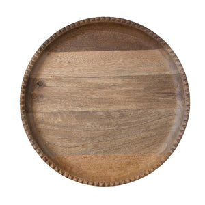 The MANGO LAZY SUSAN by CREATIVE COOP is a circular piece made from mango wood with a light brown finish. It features slightly raised scalloped edges for added texture and grip, while the smooth surface highlights the natural grain of the wood.