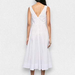 A person stands against a plain white background wearing the MEIMEIJ Sleeveless Cotton Dress in Navy. The dress features a fitted bodice and a flared skirt that falls to mid-calf. Their arms rest naturally at their sides.