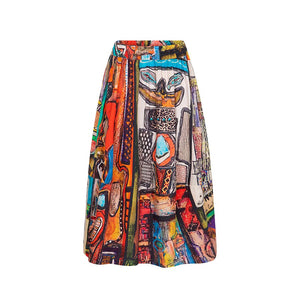 The JUJU CIRCLE SKIRT by TALKING WALLS is an A-line midi-skirt adorned with a striking black and white abstract pattern. It showcases high-end tailoring, featuring a high waist, an elastic waistband, and a pleated design that provides a flowing and voluminous appearance. The bold print includes diverse brush strokes and shapes.