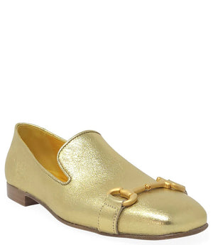 The Madison Maison Square Toe Loafer in gold metallic showcases its handmade craftsmanship and 100% leather composition. This single loafer, characterized by a low wooden heel and square toe, is adorned with a decorative gold buckle on the front. The opulent gold interior lining enhances its luxurious appeal, elegantly displayed in a side profile view against a plain white background.