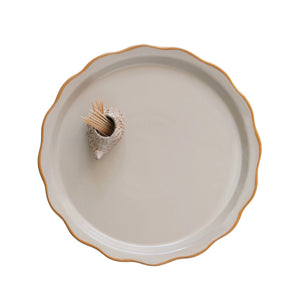 A STONEWARE PLATE WITH HEDGHOG TOOTHPICK HOLDER by CREATIVE COOP features a round, beige stoneware plate with a wavy rim and a brown edge, while the whimsical hedgehog toothpick holder adds charm to its simple elegance.