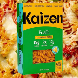 An image of a box of KAIZEN - FUSILLI pasta from KAIZEN FOOD COMPANY highlights its gluten-free, high protein, low carb, and plant-based attributes. The details on the box state: "19g Protein, 2g Net Carbs, 17g Fiber" per serving and feature the phrase "Lean into the Bean" on the side. Each box contains 8 oz (227g).