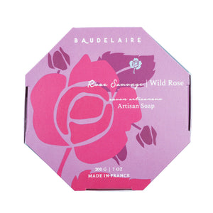 A round, pale pink bar of French-milled soap from Baudelaire, embossed with "Provence Santé" and "200 g", infused with the essence of wild rose. This luxurious bath bar is part of the Baudelaire Wild Rose collection and comes in a 7 oz boxed presentation.