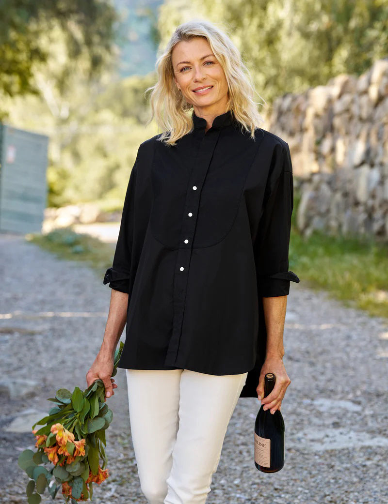 Displayed against a white backdrop is the FRANK AND EILEEN - VICTORIA ITALIAN TUXEDO SHIRT in black, featuring long sleeves and a woven jacquard bib. Inside, the label reads "Frank Kelleron Est. 1947." This luxurious Italian piece boasts a formal front panel, slightly rounded hem, and buttoned cuffs.