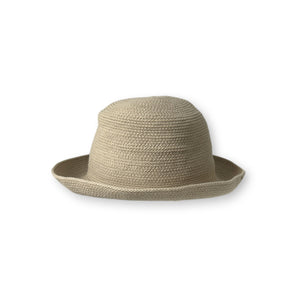 The BEACH HARE - WANDER HAT, a light-colored, wide-brimmed straw hat handmade by BEACH HARE in NYC, is showcased on a white background. It features a slightly curved brim and a simple woven pattern that exudes a casual and summery look. Additionally, it's packable for easy travel.