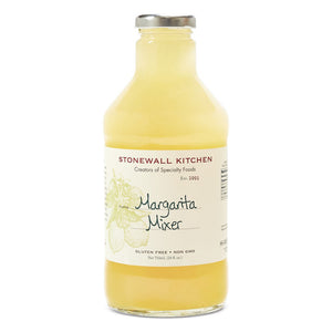 A clear glass bottle of Stonewall Kitchen Margarita Mixer is filled with a light yellow liquid. The label displays "STONEWALL KITCHEN - MARGARITA MIXER" and mentions "Gluten Free" and "Non GMO." The brand name, STONEWALL KITCHEN, is at the top, accompanied by illustrations of limes—perfect for crafting refreshing margaritas as your go-to summer cocktail.