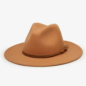 The BILLIE FEDORA HAT by WYETH is a tan wool felt fedora with a leather trim, showcasing a pinched crown and mid brim, beautifully displayed against a plain white background.