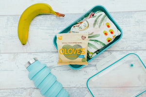 A sealed beige snack pack of POSHI brand, labeled "OLOVES - LEMON & ROSEMARY." The pack features an illustration of green olives. Text on the pack highlights it as a "Low Calorie Snack" and mentions 50 million packs sold. Pack size is 30g (1.1 oz).