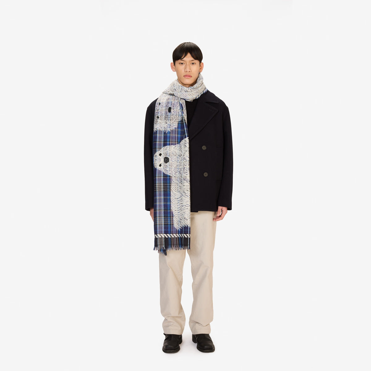 The INOUI FREDDY DOG SCARF IN 3D BLUE by INOUI is a rectangular, blue plaid wool-cotton scarf featuring white sketch-like dog drawings and fringed edges on both short sides, made in India.