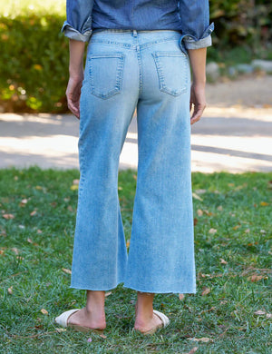 The FRANK & EILEEN GALLWAY Wide Leg Jean in Italian Dream Denim 1986 Mineral Wash features a high waist, classic five-pocket design, and hand-distressed raw hem, shown on a plain white background.