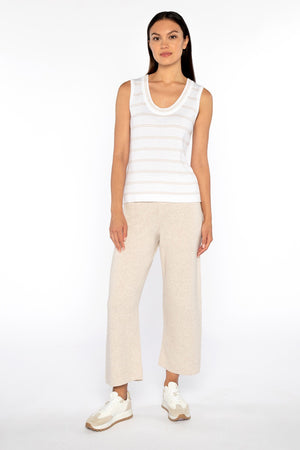 A person is wearing a white V-neck long-sleeve sweater and KINROSS CASHMERE COVERSTITCH SROP COTTON BLEND wide-leg cropped pants. Standing on a white background, the outfit includes white sneakers with beige soles, highlighting a comfortable, casual style.