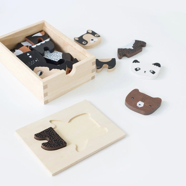 A wooden toy set titled &quot;WEE GALLERY - MIX &amp; MATCH ANIMAL TILES&quot; by WEE GALLERY shown on a white background. The visible toy piece features a cartoonish animal, combining traits of a fox and a bear, painted in brown, white, and black colors. Perfect for creative play and developing motor skills, the toy is presented in a wooden box.