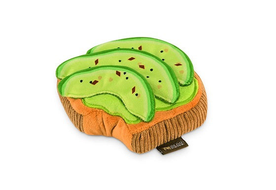 The BARKING BRUNCH MINI AVOCADO TOAST from PLAY PET LIFESTYLE is an adorable plush toy designed to resemble a slice of toast topped with green avocado slices, complete with black seeds and red pepper flakes. This brunch-themed pet toy features a small fabric tag on the right side, making it one of the most durable and charming options available for your furry friend.