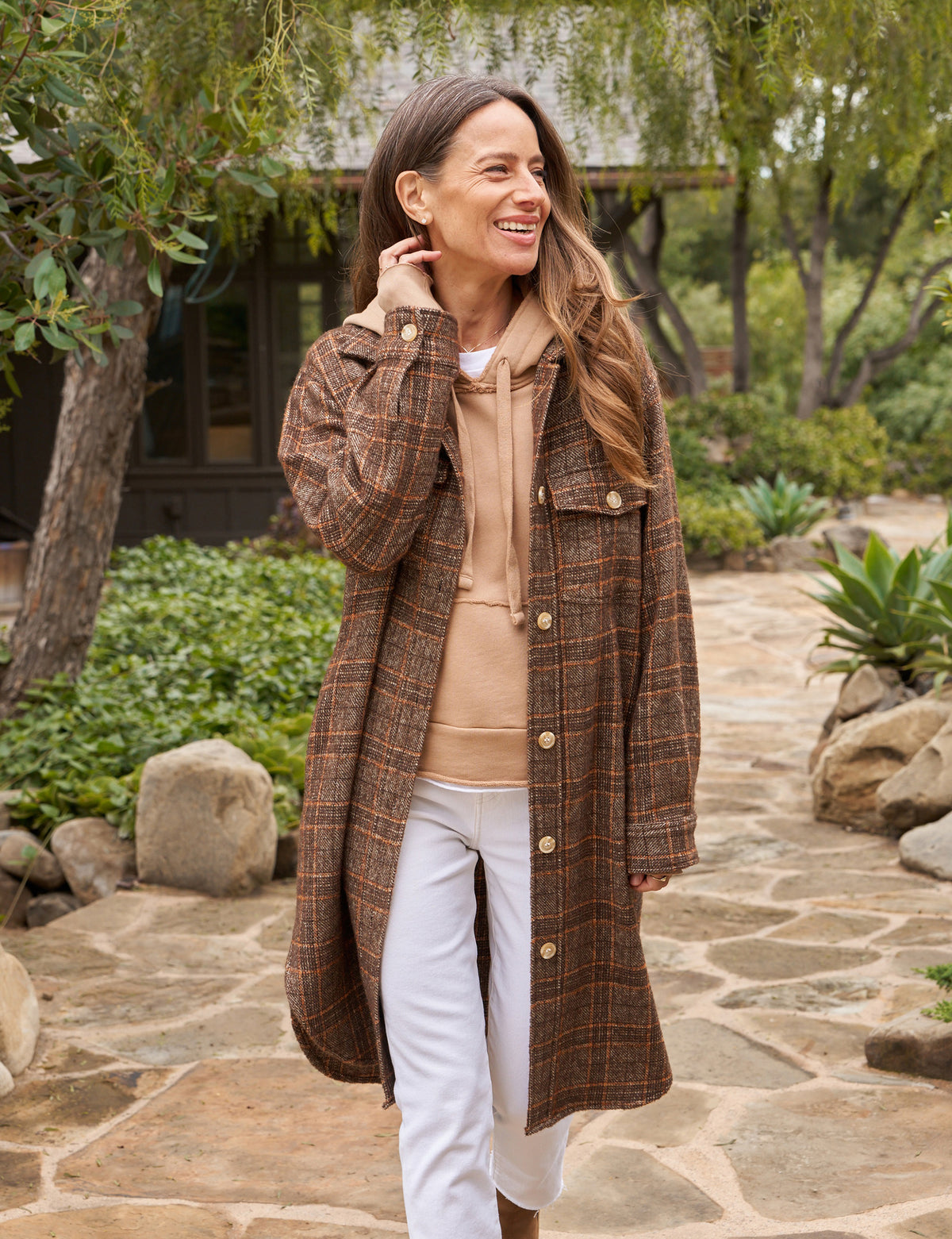The Gavin Italian Boucle Shirt Jacket from Frank &amp; Eileen is a long, plaid coat in shades of brown with an oversized fit. Made from luxurious pre-washed wool, the coat features a collared neckline, button closure, and two large front pockets. Sleeves are rolled to mid-length and the fabric showcases a textural, woven appearance. The tag inside reads &quot;Frank &amp; Ellen.