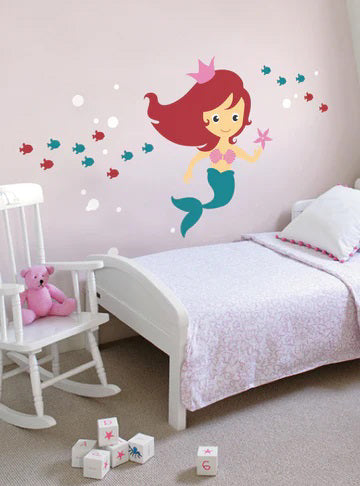 An illustration labeled "scheme A" from the SIMPLE SHAPES - UNDER THE SEA REMOVEABLE WALL DECALS by SIMPLE SHAPES depicts a smiling mermaid with red hair, a pink crown, and a turquoise tail, holding a pink starfish. Small red and blue fish surround her as she swims against an off-white background—perfect for mermaid decor or as customizable colors mermaid wall decals.