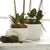 Three white, tapered shape ceramic planters of varying sizes are shown. The smallest planter, named SINCLAIR CACHEPOT (S) by NAPA HOME AND GARDEN, is on the right. The medium planter is on the left, and the largest planter is in the middle. These contemporary selections feature a ribbed pattern and have a smooth, glossy finish.