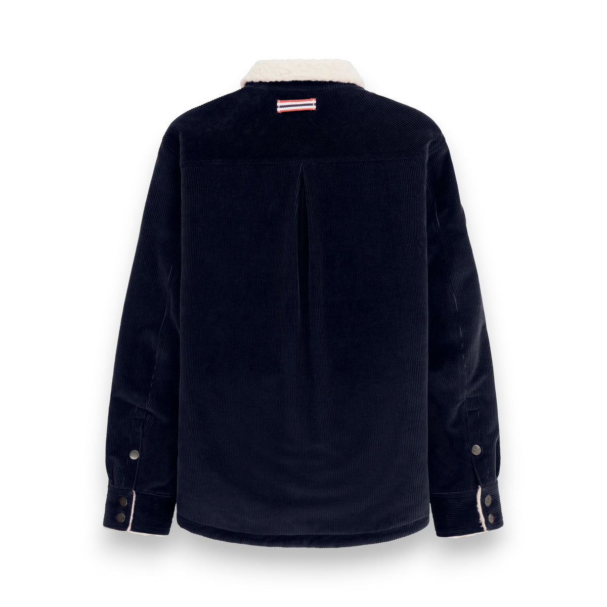 The AMUNDSEN SPORTS Harvester Overshirt in True Navy is a stretch cotton corduroy jacket with white sherpa trim, chest and side pockets, snap buttons, and a circular left-sleeve patch.