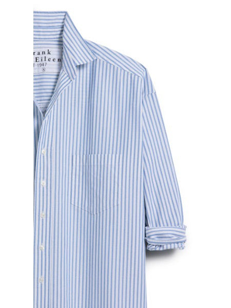 The FRANK &amp; EILEEN Finbar men&#39;s button-up shirt in blue stripe oxford features light blue and white vertical stripes, a chest pocket, rolled-up sleeves, and breathable Italian oxford cotton, shown from the chest up against a white background.