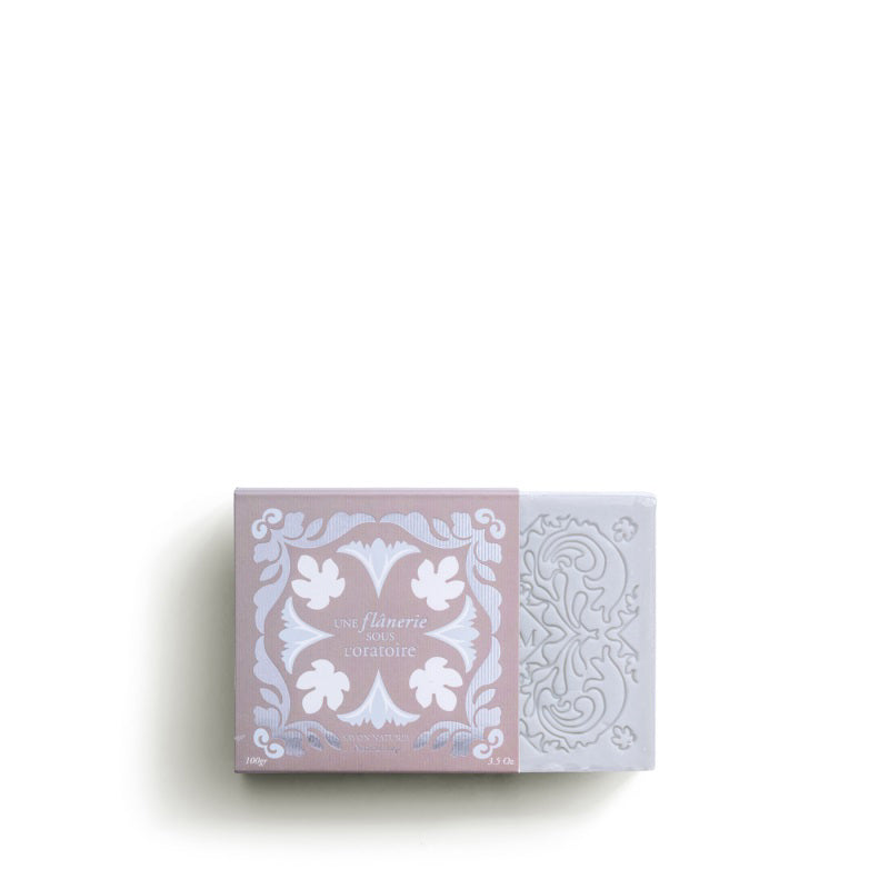 The ROSE ET MARIUS &quot;A Stroll Under the Oratory&quot; scented soap gift box features a decorative bar of artisanal soap, partially slid from its pink and white floral-patterned packaging, inspired by Provence.