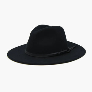 The BILLIE FEDORA HAT by WYETH is a tan wool felt fedora with a leather trim, showcasing a pinched crown and mid brim, beautifully displayed against a plain white background.