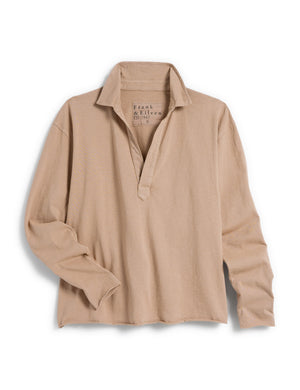 A long-sleeved, light beige FRANK & EILEEN Patrick Popover Henley shirt in Heritage Jersey with a V-neck opening and a cropped hem, laid flat against a white background. The label inside the collar is partially visible, and the shirt appears casual and slightly wrinkled.