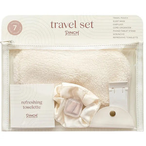 The PINCH PROVISIONS Travel Set is neatly presented in a transparent zippered pouch, designed for the contemporary traveler. Inside, you'll find a plush sleep mask, earplugs, cord organizer, phone/tablet stand, scrunchie, and a refreshing towelette. The packaging boasts a minimalistic design with "PINCH PROVISIONS - TRAVEL SET" and highlights the included 7 essentials.