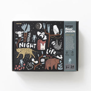 The WEE GALLERY - NIGHTLIFE FLOOR PUZZLE features whimsical illustrations of forest animals, plants, and night sky elements. The large 24-piece floor puzzle promotes motor skill development and is constructed from eco-friendly materials. Designed by WEE GALLERY, it is suitable for ages 3 and up.