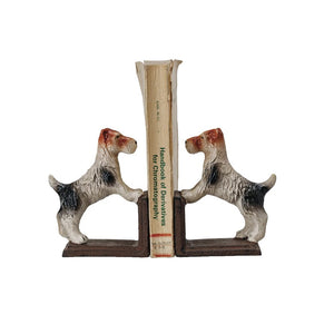 The CAST IRON JACK RUSSELL TERRIER BOOKENDS by CREATIVE COOP feature charming dog figurines with their front paws raised on a sturdy base, perfectly supporting a selection of standing books. These white dogs with distinctive brown and black markings make an ideal addition to any dog-loving bibliophile’s decor. The bookends are displayed on a light-colored surface against a neutral background.