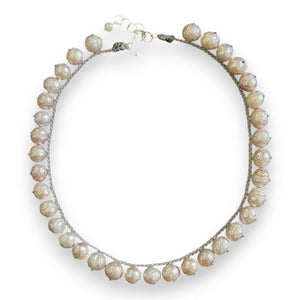 Introducing the ANN LIGHTFOOT - FRESHWATER PINK PEARL COLLIER NECKLACE, featuring a single strand of beautifully irregular freshwater pink pearls, each artfully separated by decorative knots and finished with a sterling silver clasp.