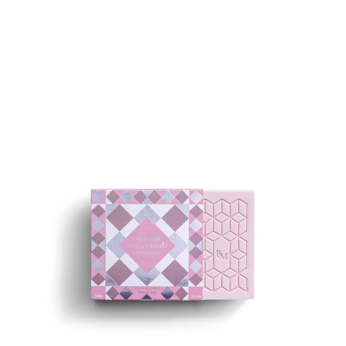 The ROSE ET MARIUS &quot;A Siesta in a Sunlit Home&quot; scented soap gift box features a pale pink, square soap with a geometric raised pattern and &quot;RM&quot; embossed in the center, shown against a white background.
