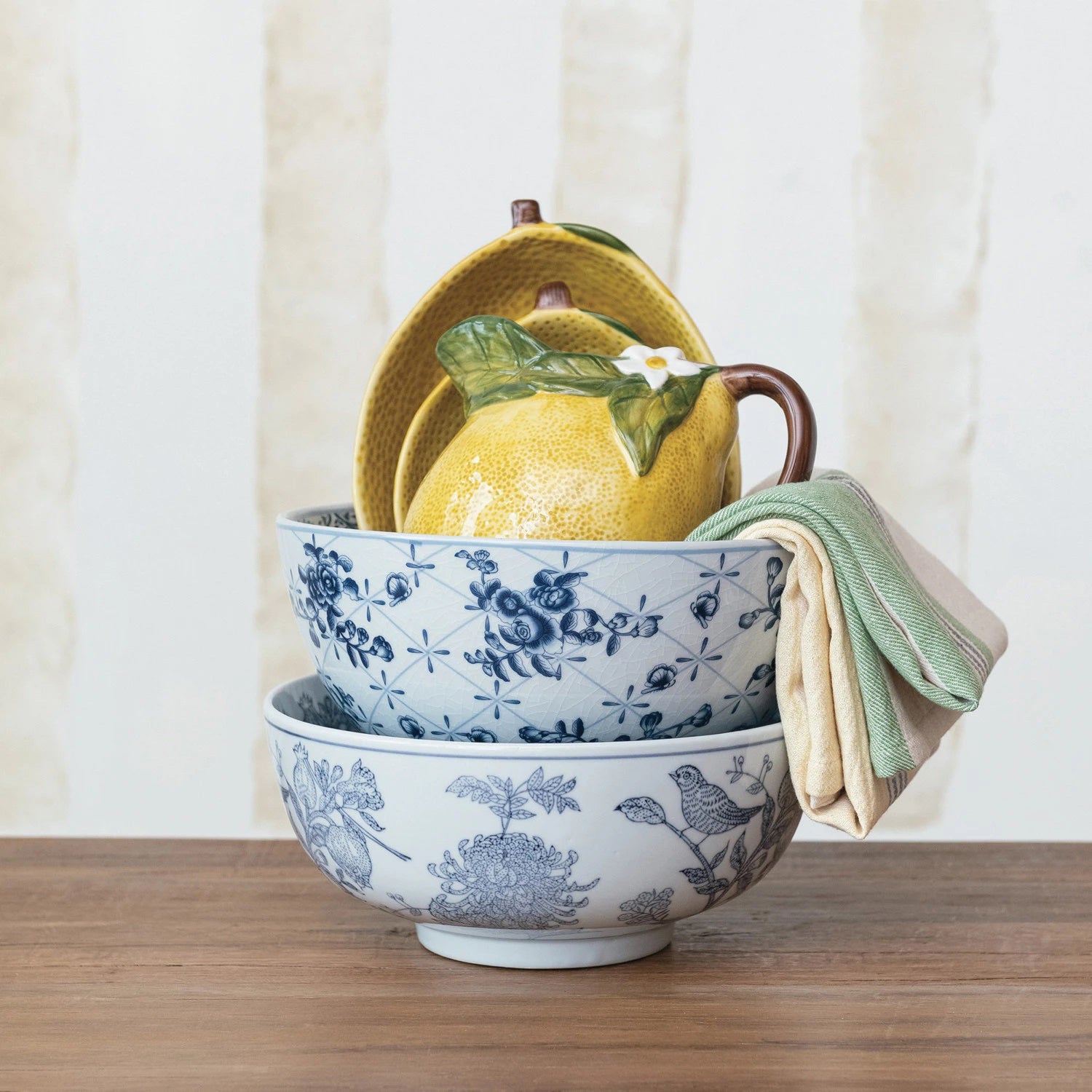 Two views of the CREATIVE COOP Porcelain Bowl with Botanicals are shown. The bowl features intricate floral and geometric patterns on both the interior and exterior surfaces. The top view displays the inner design, while the side view highlights the outer pattern, making it an exquisite addition to home decor.