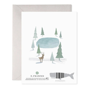 The "ALL IS CALM GREETING CARD" by E.FRANCES PAPER showcases a minimalist illustration of a deer by a small pond, encircled by trees. The design is printed on luxurious heavyweight paper and is accompanied by a gray envelope, featuring the brand’s name and a whale silhouette at the bottom.