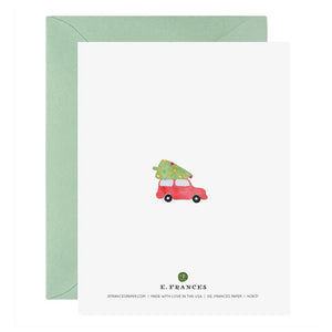 The FA LA LA LA LA TREES HOLIDAY CARD from E.FRANCES PAPER is a handcrafted watercolor greeting card featuring green trees and a small red car, with the phrase "Fa la la la la" among the foliage. Made in the USA, this festive Christmas card comes with a light green envelope, making it perfect for spreading holiday cheer.