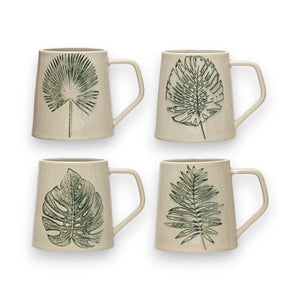 The CREATIVE COOP MUG WITH DEBOSSED LEAF set includes four stoneware mugs with handles, each adorned with a unique green leaf design: fan palm, monstera leaf, broad leaf with distinct veins, and a fern-like leaf. Arranged in a 2x2 grid on a white background, these mugs feature intricate debossed leaf patterns enhanced by reactive crackle glaze.