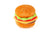 The AMERICAN CLASSIC BURGER by PLAY PET LIFESTYLE, a plush toy shaped like a classic American hamburger, is pictured against a white background. This foodie delight features a soft, brown bun with sesame seeds, green lettuce, a slice of red tomato, yellow cheese, and a brown burger patty.