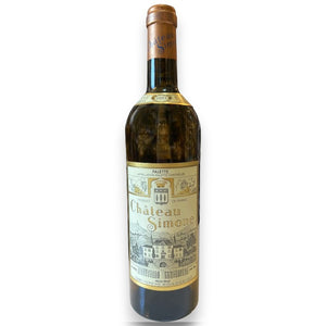 A bottle of CHATEAU SIMONE PALETTE BLANC 2021 by WINE: HAW RIVER WINE MAN features a detailed illustrated label with a chateau, vineyards, gold accents, brown foil capsule, and vintage year near the neck, evoking its historic Provencal estate origins.