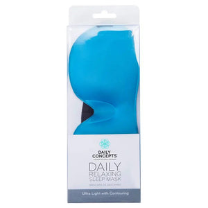 A packaged blue RELAXING SLEEP MASK from DAILY CONCEPTS. The packaging is transparent at the top, showcasing the lightweight sleep mask, and white at the bottom, displaying the brand’s name and product description: "RELAXING SLEEP MASK - Ultra Light with Contouring and Velcro Strap.