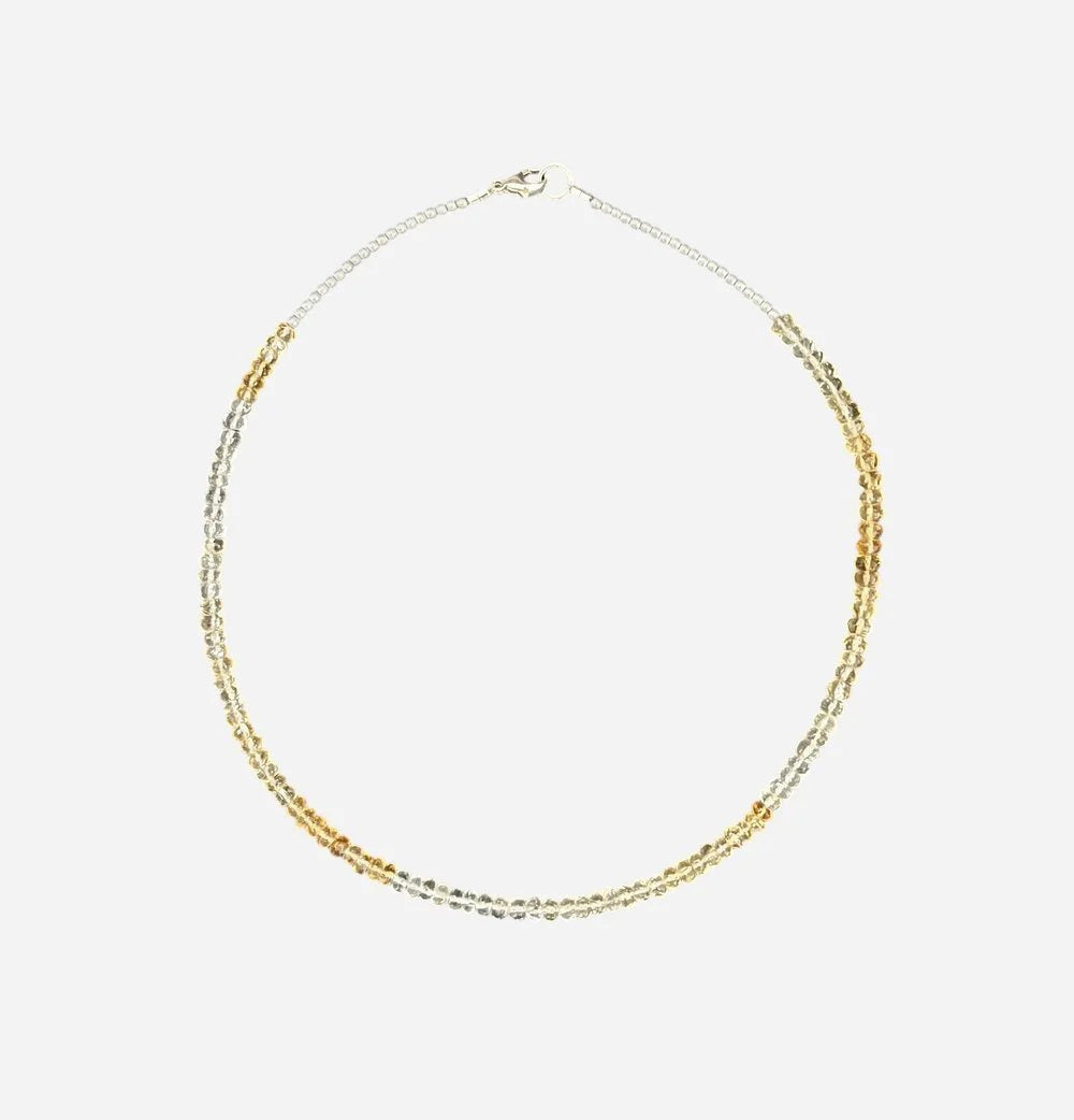 The ANN LIGHTFOOT - FACETED CITRINE RAS DU COU NECKLACE features faceted citrine stones with alternating silver and gold beads in a symmetrical design, secured by a sterling silver clasp, shown on a plain white background.