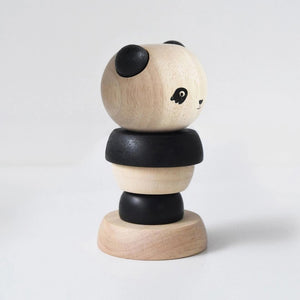 A white packaging box is labeled at the top with "WEE GALLERY" and at the bottom with "PANDA WOOD STACKER." The box features an image of a wooden stacker toy resembling a panda, consisting of alternating black and natural wood rings, designed to enhance fine motor skills through creative play.